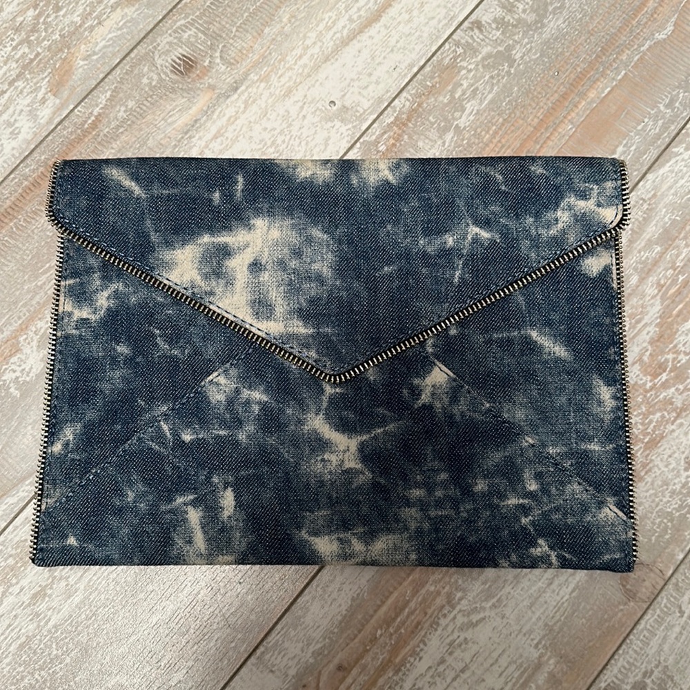 Rebecca Minkoff's Leo clutch trimmed with zipper panels. envelope silhouette.